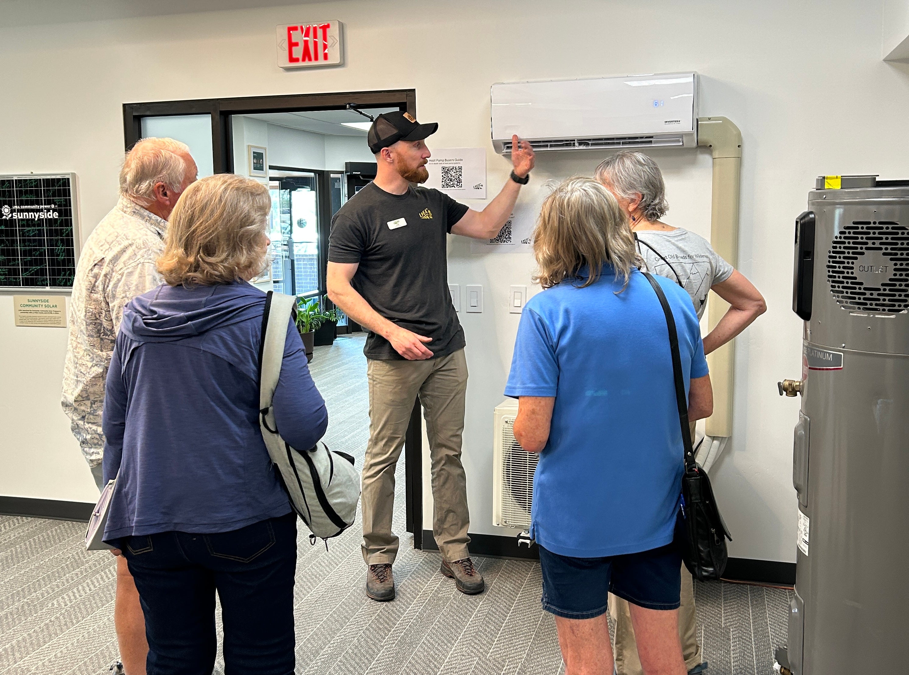 A man and woman discuss beneficial electrification