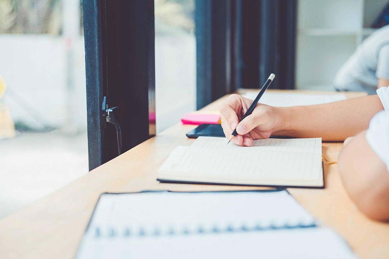 person writing in a notebook
