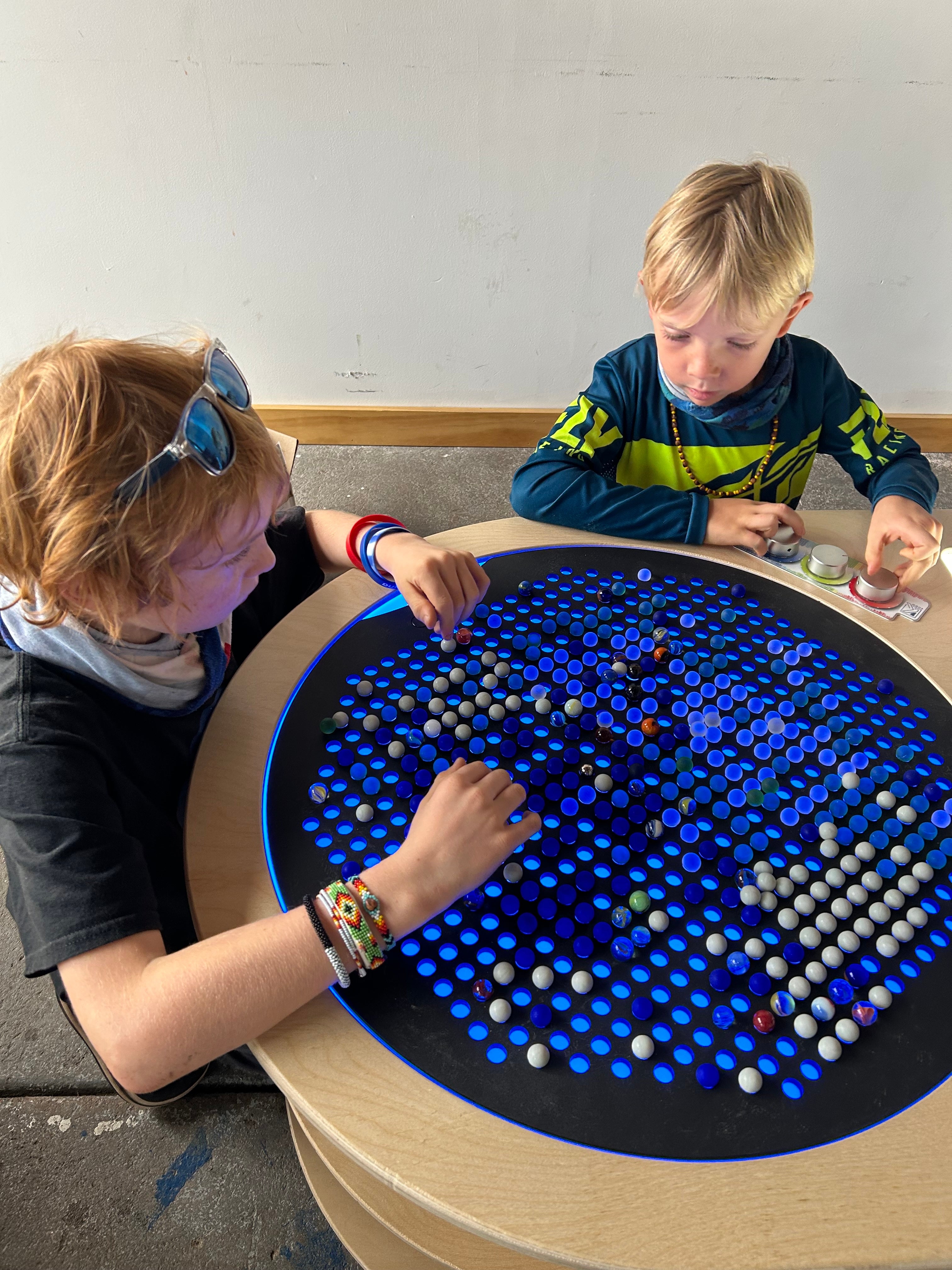 Kids at a light table at the Power House Science Center