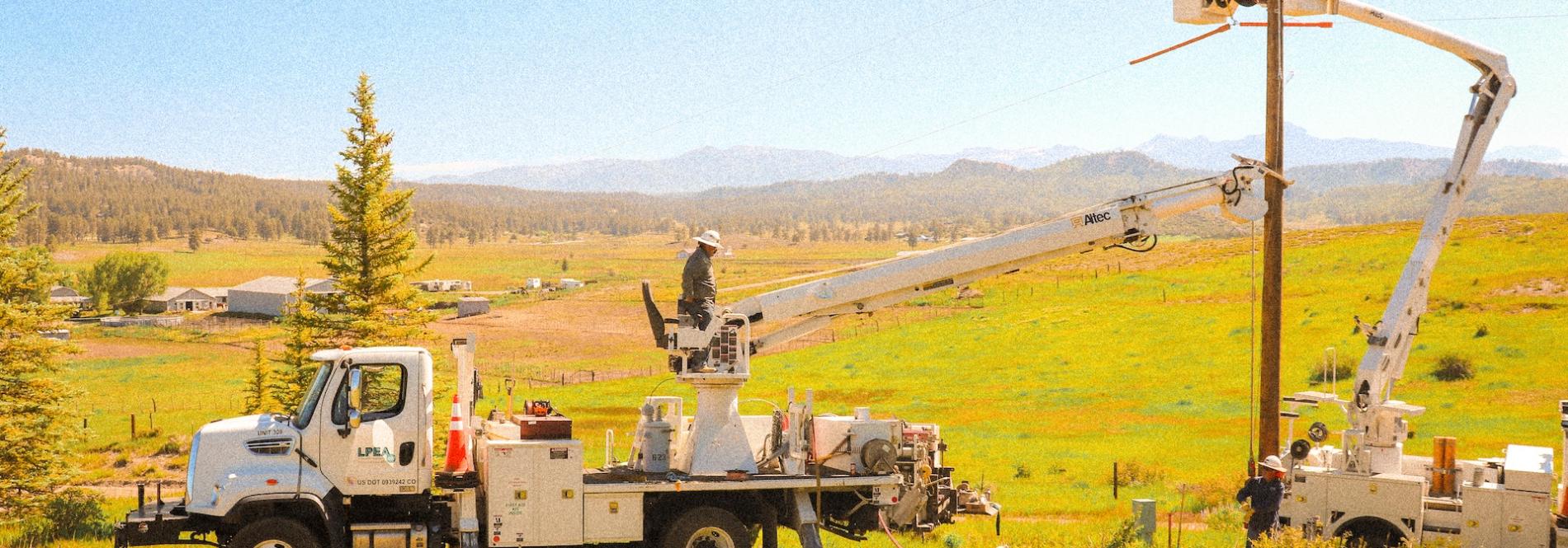 Lineworkers working in bucket trucks in southwest Colorado